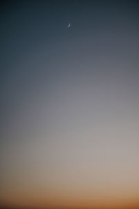 Low angle view of moon against clear sky at night