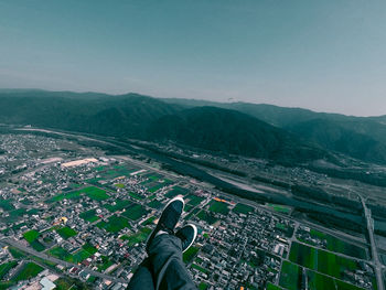 High angle view of man and mountains against clear sky