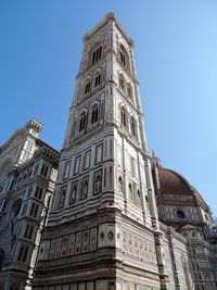 Low angle view of historic building against clear blue sky