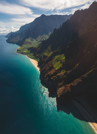 High angle view of sea and mountains against sky