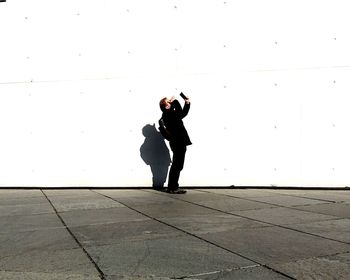 Full length of woman standing by railing