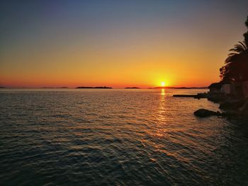 Scenic view of sea against clear sky during sunset