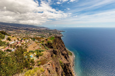 High angle view of townscape by sea against sky
