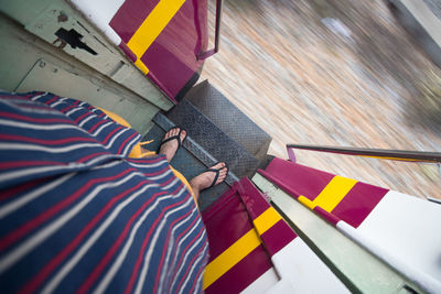 Low section of people on multi colored umbrella