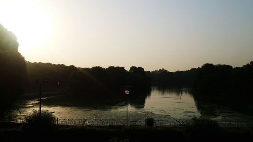 Scenic view of river against sky at sunset