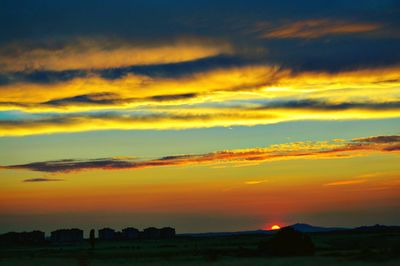 Silhouette landscape against sunset sky