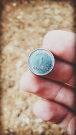 Close-up of hand holding coins