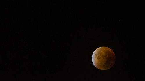 Scenic view of moon against clear sky at night