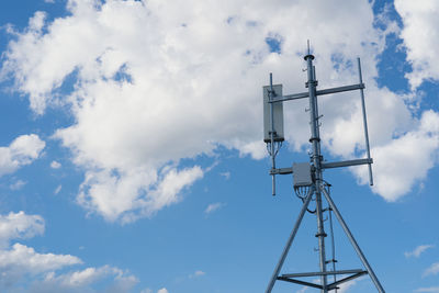 Low angle view of communications tower against sky