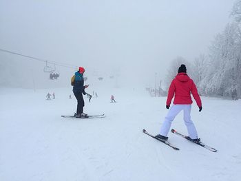 People skiing on snow during winter