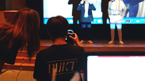 Rear view of women with text