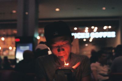 Close-up of young woman with illuminated lights