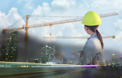Double exposure image of engineer with construction site