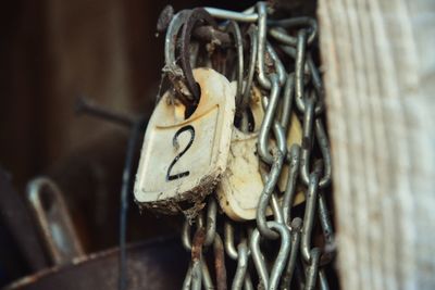 Close-up of rusty chain hanging on rope