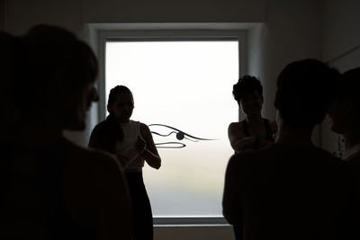 Group of women practicing pilates exercises in class