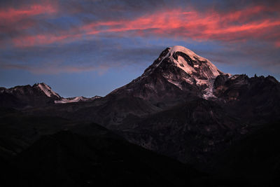 Scenic view of snowcapped mountains against sky during sunset