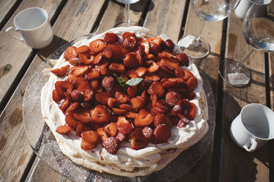 Meringue with strawberries on table
