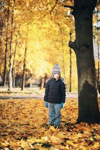 Man standing by tree during autumn