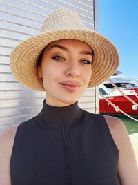 Portrait of young woman wearing hat