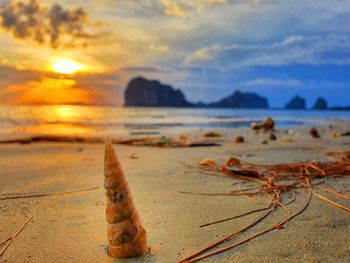 Scenic view of beach against sky during sunset