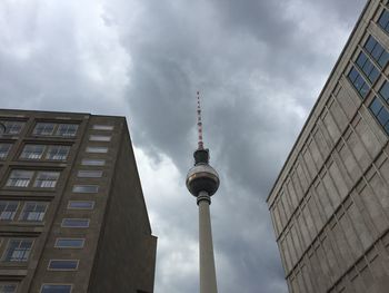 Low angle view of eiffel tower against cloudy sky
