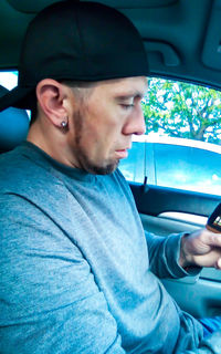 Portrait of man sitting in car