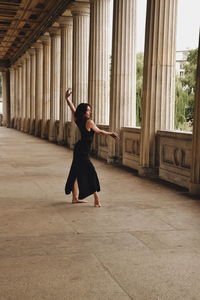 Full length of young woman dancing on floor