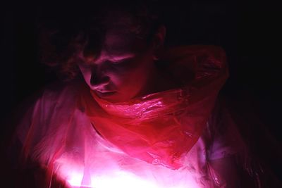 Close-up of young woman in darkroom