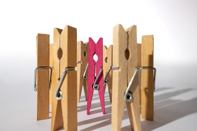 Close-up of clothespins on table against white background