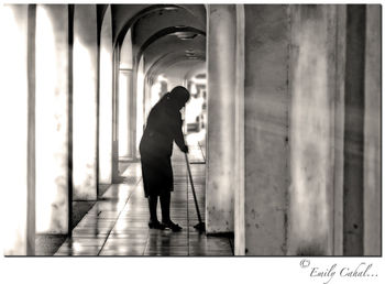 Rear view of man walking in corridor