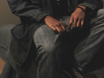Midsection of man sitting on floor