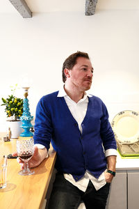 Man looking away while sitting on table