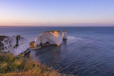 Scenic view of sea against clear sky at sunset