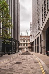 Street amidst buildings in city against sky