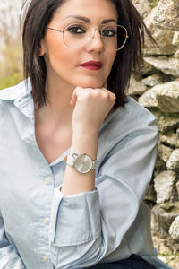 Portrait of beautiful woman against wall