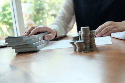 Midsection of man playing piano on table