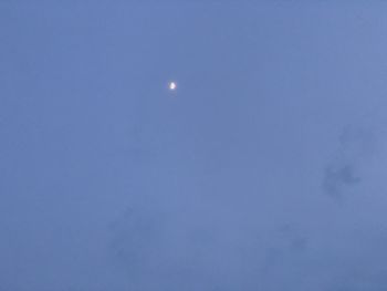 Low angle view of moon against blue sky at dusk