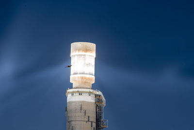 Low angle view of smoke stack against sky