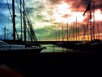 Sailboats in sea at sunset