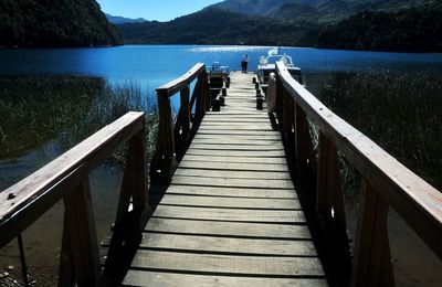 Pier over lake against mountains