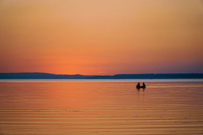 Scenic view of sea against orange sky