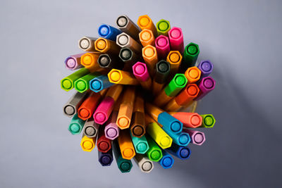 High angle view of colored pencils against white background