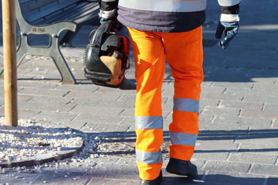 Low section of woman walking on street