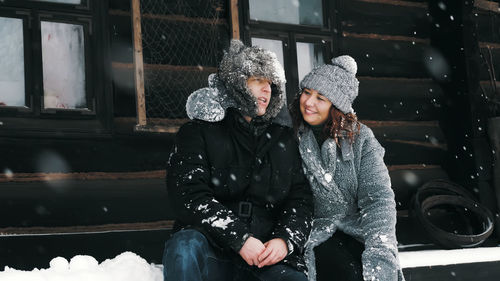 Winter portrait. happy, funny couple in love, man and woman, dressed in warm winter clothes