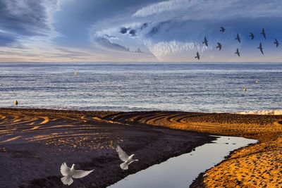 Scenic view of sea against sky at sunset