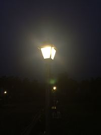 Low angle view of illuminated street light at night