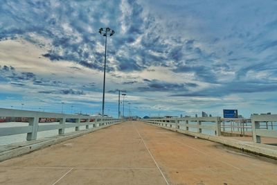 Empty road against sky in city