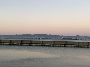 Scenic view of sea against clear sky during sunset