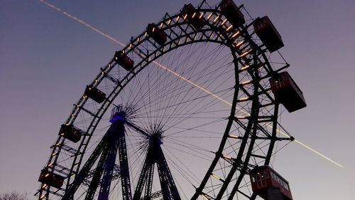 Low angle view of ferris wheel against sky