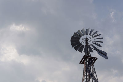 Low angle view of traditional windmill against sky